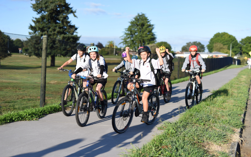 A group of schoolchildren biking to school